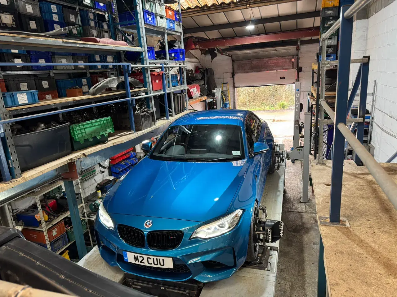 Blue BMW M2 in the Janz Performance workshop